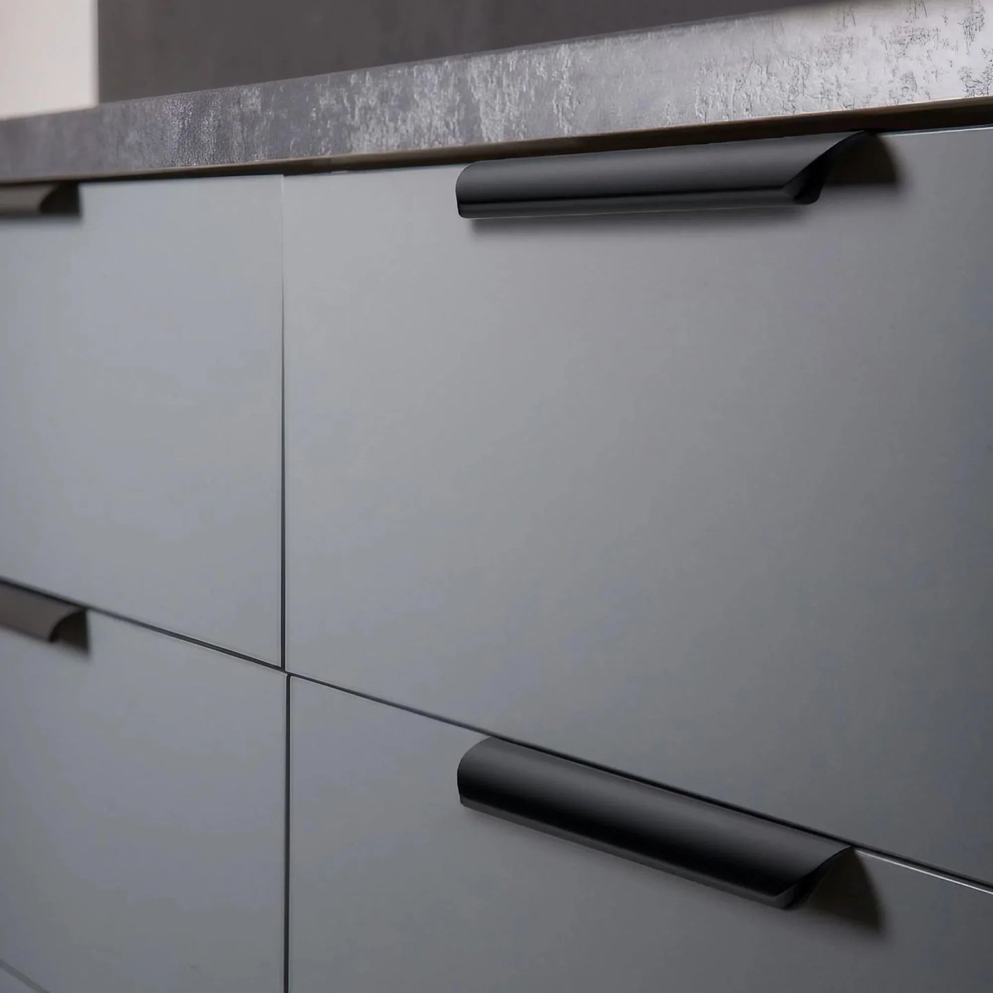 Matte black cabinet edge handle on the kitchen drawer