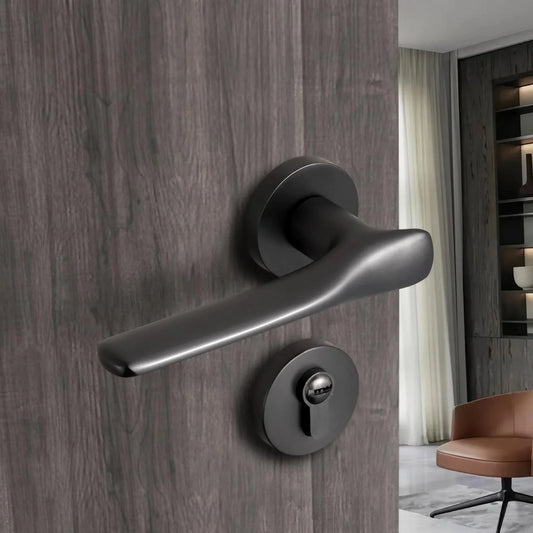 Brushed black nickel modern interior door handle with lock installed on wooden bedroom door