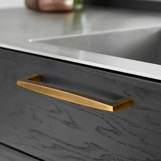 Brushed Brass kitchen cabinet handles installed on modern drawers with minimalist cabinet design