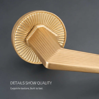 Close-up detail of ribbed zinc alloy interior lever door handle with premium brushed finish
