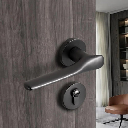 Brushed black nickel modern interior door handle with lock installed on wooden bedroom door